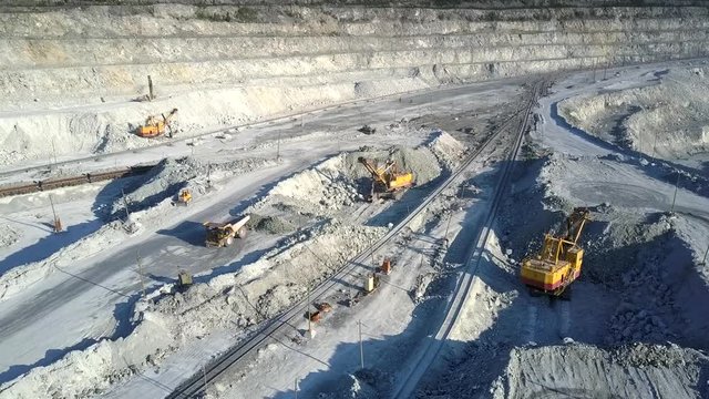 upper view open asbestos deposit with excavators and trucks