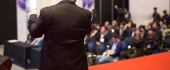 Audience Watching a Presentation. Defocused Blurred. Presenter During Conference Meeting