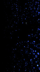 Glowing particles, polka dots on a dark blue background. Vertical festive banner. An elegant holiday pattern. Vector illustration