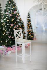 white chair with Christmas tree background