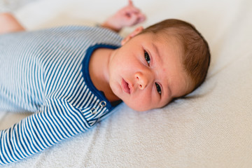 Face portrait of a newborn baby, calm and relaxed.