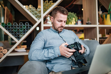 Young photographer reviewing photos on camera.