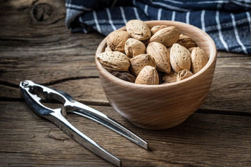 Almonds in-shell in wooden bowl.