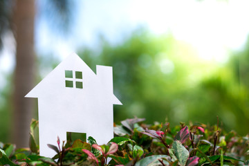 Paper House on field bokeh background with copy space