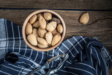 Almonds in-shell in wooden bowl.