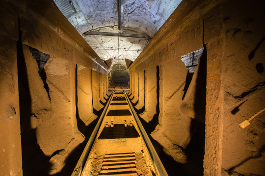 Underground gold iron ore mine shaft tunnel gallery passage with wagon tipper