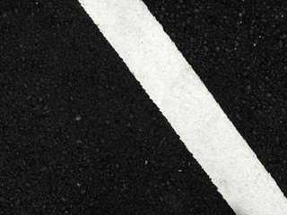 Black paved road background.