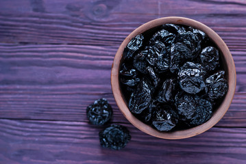 Clay bowl filled with juicy prunes