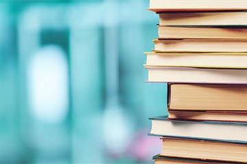Stack of colorful books on blurred background