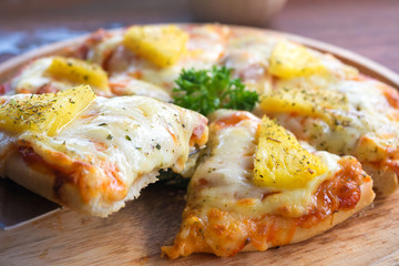 close up of Hawaiian pizza juicy pineapple chunks ham bits melted mozzarella cheese