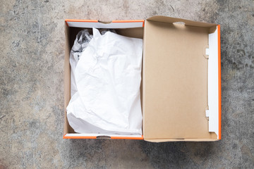 Shoes packaging cardboard box with crumpled wrapping paper