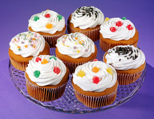 PLATE OF ICED CUPCAKES OR MUFFINS