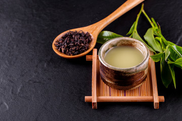 Top view of green tea matcha in a bowl on wooden surface