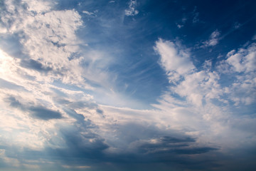 Obraz premium White curly clouds in a blue sky. Sky background