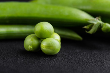 Sugar snap peas with mint on a rustic wood background