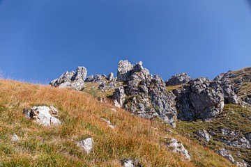 Fototapeta na wymiar Panoramic view of the towers and spiers of the southern Grigna from the direct route, on a sunny autumn day.