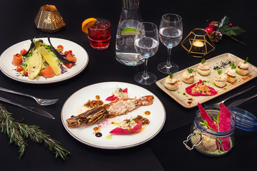 Tasty restaurant dishes: Cooked and stuffed crayfish, salad, appetizers, and crayfish ice-cream