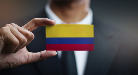 Businessman Holding Card of Colombia Flag