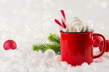 Winter hot drink, cacao with marshmallows or spicy hot chocolate in red cup. Festive vintage background. Copy space for text.