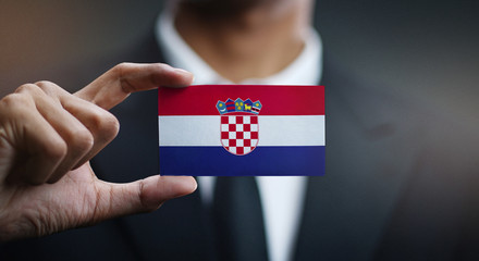 Businessman Holding Card of Croatia Flag © natanaelginting