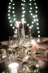 christmas eve party table with wine glass and glitter season's greeting decoration