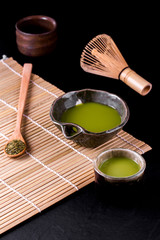 Top view of green tea matcha in a bowl on wooden surface