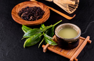 Top view of green tea matcha in a bowl on wooden surface