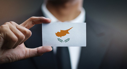 Businessman Holding Card of Cyprus Flag © natanaelginting