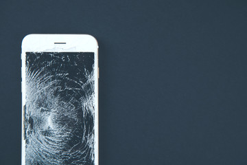 broken phone on black background