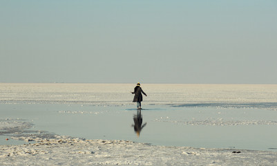 A girl with reflection in the salt lake
