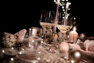 christmas eve party table with wine glass and glitter season's greeting decoration