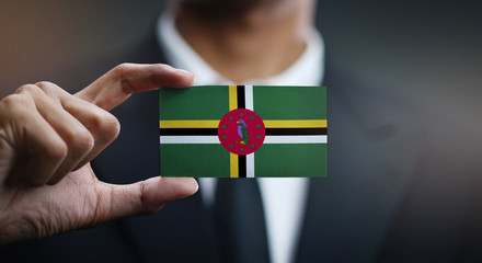 Businessman Holding Card of Dominica Flag
