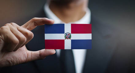 Businessman Holding Card of Dominican Republic Flag
