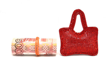 Red bag and money on white background close up