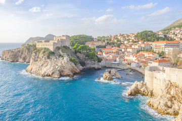 Fototapeta na wymiar Scenic view of Fort Lovrijenac in ancient touristic town Dubrovnik in Croatia. Beautiful aerial view of fortress on cliff in sunset light in old european resort on Adriatic sea.