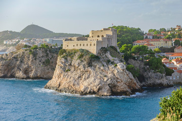 Scenic view of Fort Lovrijenac in ancient touristic town Dubrovnik in Croatia. Beautiful aerial view of fortress on cliff in sunset light in old european resort on Adriatic sea.