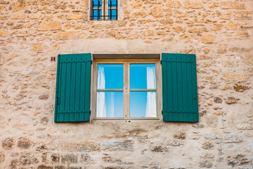 Old window with wooden shutters in Provence - traditional design and architecture
