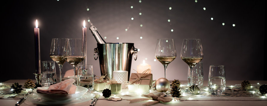 Christmas Eve Party Table With White Wine Glass And Glitter Season's Greeting Decoration Horizontal Header