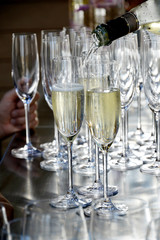 Pour the champagne into the flute glass