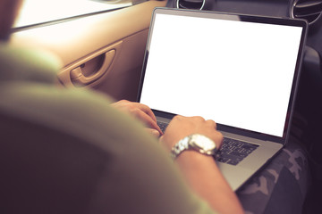 Business man or Freelancer sitting in the front seat of a car working behind a laptop close-up,warm...