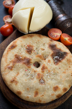 Close-up of ossetian pie with meat stuffing, selective focus, vertical shot