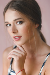 Fototapeta premium A young beautiful Caucasian woman with gathered hair.