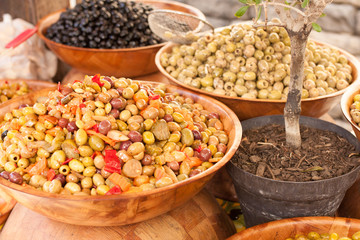 Marinated olives and garlic on the counter in the market - Luberon, Provence, France