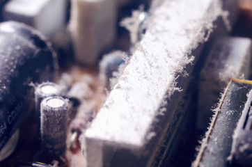 A thick layer of dust covers the internal electronic components of the computer