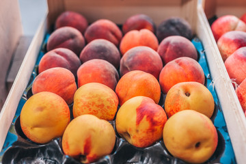 Fresh ripe large peaches in a crate