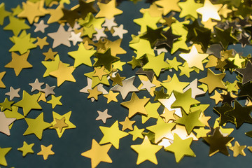 Golden confetti stars scattered on the surface.