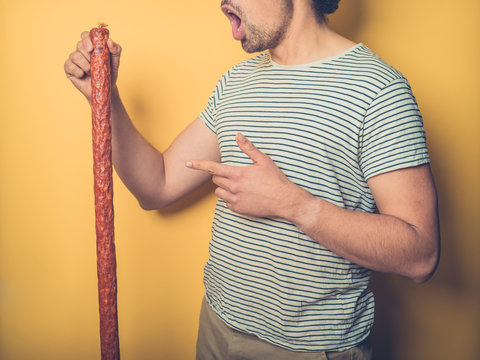 Young man amazed by the size of his sausage