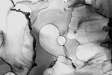 Gold alcohol ink wash texture on clean paper background. Liquid paint flow. Transparent ethereal effect.