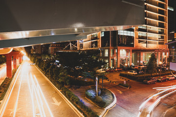 KUALA LUMPUR, MALAYSIA - NOVEMBER 18 2018 : Night traffic light trail at Bandar Sunway in front of the Sunway City. In conjunction with Artbox 2018 event