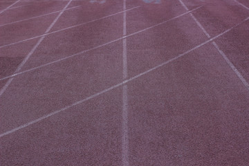 poor soft color running track on sport  stadium place background texture surface with marking and empty copy space